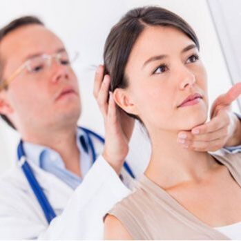 Neurologist examines a patient with neck pain